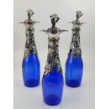 Three Victorian style blue glass decanter, silver plate mounted with fruiting vines. H.