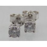 A pair of diamond ear studs, apros 0.4ct, claw set in white metal stamped 750, 1.2g.