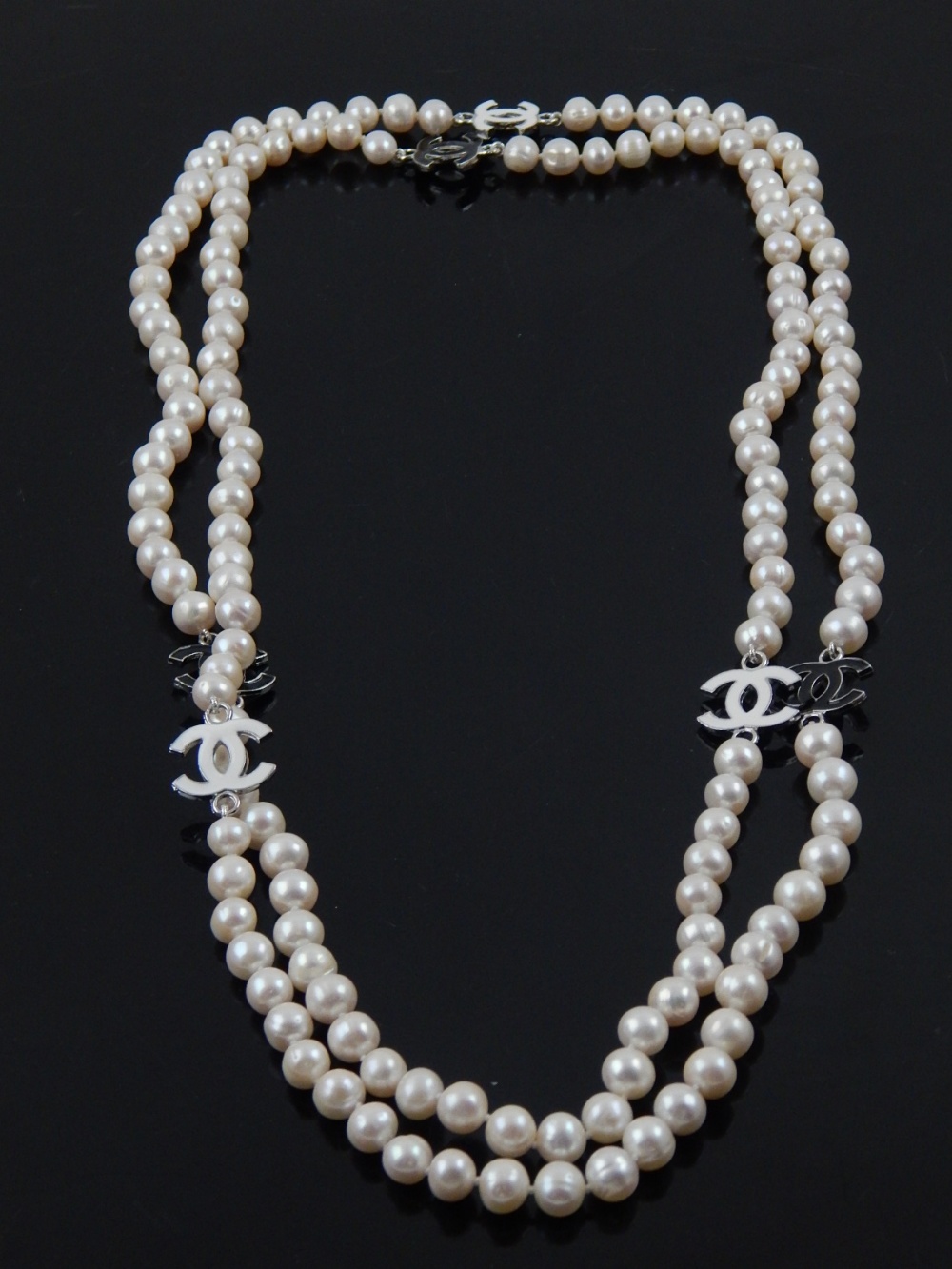 A long string of cultured pearls, with Chanel style spacers.