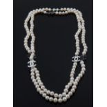 A long string of cultured pearls, with Chanel style spacers.