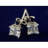 A pair of silver and cubic zirconia ear studs.