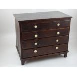 A Victorian oak four drawer miniature chest with turned bone knob handles. W.