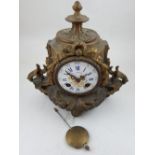 A late 19th century gilt metal mantel clock the eight day movement striking on a bell with circular