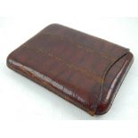 An early 20th century crocodile skin cigar case, beard Drew and Son retail mark.