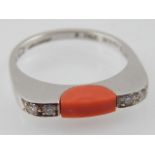 An Art Deco style coral and diamond ring, set in a 15ct white gold band, 2.7g.