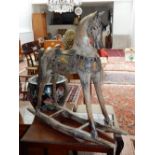 A distressed silver and polychrome painted rocking horse, H. 80cm.