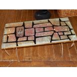 A vintage coffee table circa 1960's, the rectangular top of a gilt iridescent brick design