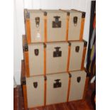 A graduated set of three Edwardian style canvas covered wood bound travelling trunks. W. 80cm (