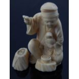 A late 19th century ivory okimono fashioned as a seated Buddha holding bid, H. 7cm