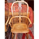 A late 19th century ash and elm Windsor chair, with a pierced splat and contoured seat above a