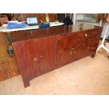 An Eastern hardwood side cabinet, fitted with an arrangement of four cupboard doors and frieze