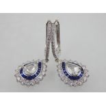 A pair of white metal, diamond, and sapphire drop earrings, set rose cut central stones of approx.