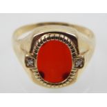 A gentleman's 9ct yellow gold, diamond and carnelian dress ring.