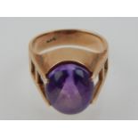 A cabouchon amethyst dress ring, claw set in a 14ct yellow gold band, 6.9g.