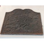 An 18th century style cast iron fireback, decorated with angels amongst clouds. H. 54cm