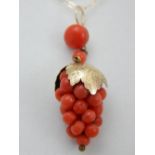 A 9 carat yellow gold and coral style pendant fashioned as a grapevine, suspended on a 9 carat
