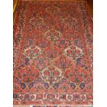 A Qum carpet, decorated with floral panels, fringed. 202 x 156cm