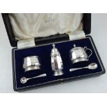 A silver condiment set, Birmingham 1950 by Walker & Hall, to include salt and mustard pot with