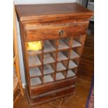 A Provincial style hardwood 16 bottle wine cabinet, fitted three drawers.