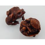 Two Japanese carved boxwood netsuke modelled as a toad and a tortoise.