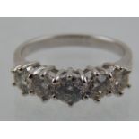 A white metal and five stone diamond ring, set round cut stones of approx. 1.40cts combined.