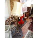 An early 20th century adjustable standard lamp, converted from an oil lamp. H. 154cm