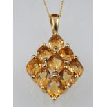 A 9ct yellow gold, citrine nine stone cluster pendant, on a fine link chain.