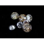 Seven unmounted round cut diamonds, of assorted colour, size and clarity, total weight approx. 6.