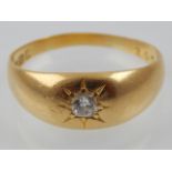 An yellow gold and central diamond set gypsy ring, 18 carat