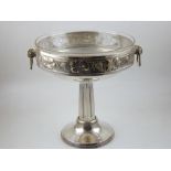 A Jugendstil silverplated WMF twin handled tazza with clear glass liner, the border repousse