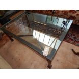 A modern rectangular cast metal glass top coffee table, with X-stretcher. L. 128cm