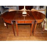 A George III style mahogany D-end dining table, including a central drop-leaf section, on tapered