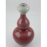 A Chinese sang de boeuf double gourd vase, with a six character mark to base, H 24cm,