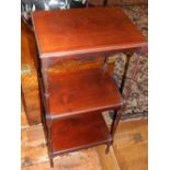 An Edwardian mahogany three tier whatnot on slender turned supports.