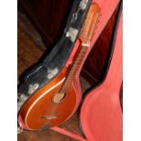 A 20th century mandolin, with spruce face and rosewood fingerboard, with a hard case,