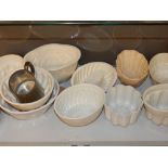 A collection of twelve Victorian and later stoneware jelly moulds, and a pewter tankard.