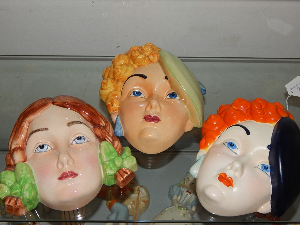 Three Beswick pottery wall masks, circa 1930, pattern numbers girl with plaits 393, black beret 314,