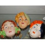 Three Beswick pottery wall masks, circa 1930, pattern numbers girl with plaits 393, black beret 314,