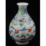 A Chinese Doucai vase, of baluster shape, decorated with a continous design of figures playing,