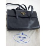 A Prada rectangular black leather shoulder handbag, together with dust bag.