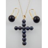 A 9ct gold mounted black pearl crucifix pendant, together with a pair of black pearl drop earrings.