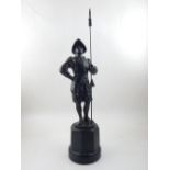 An early 20th century bronze of a conquistador, standing has ease and holding a pike, H. 46cm.