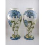 A pair of Art Nouveau style porcelain baluster vases, floral decorated. H.