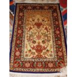 A cream ground Herkeh prayer rug, decorated with scrolling foliage and birds to centre,