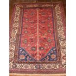 A red ground Caucasian rug,