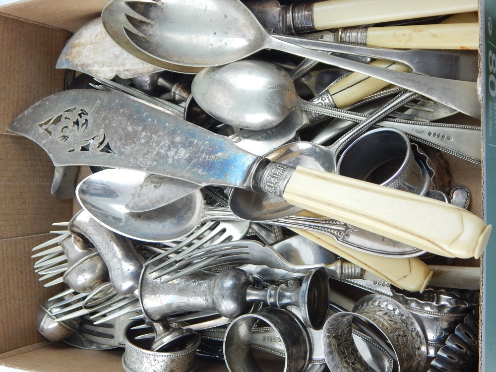 A quantity of plated flatware, including fish servers and various spoons and forks,