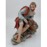 A Capodimonte handpainted porcelain study of seated fisherman, H.24cm.