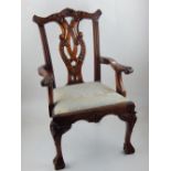 A reproduction George III style miniature elbow chair.