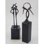 A bronze figural study of a man and woman entwining arms, raised on rectangular base,