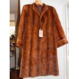 A ladies brown fur coat, approx. size L.